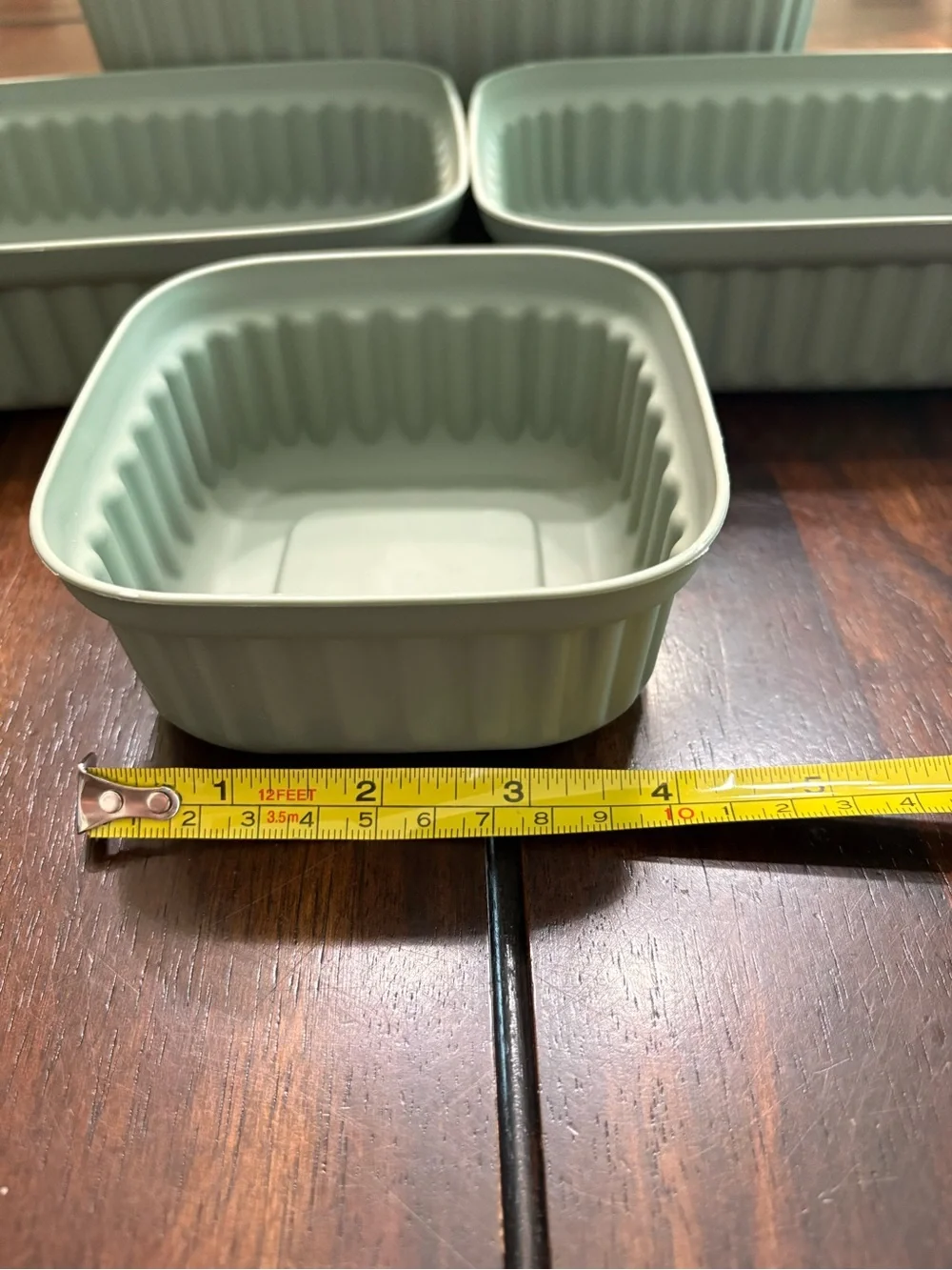 Set of 7 sage green plastic storage containers
